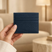 Navy ALTAIR cardholder being carried, with the ALTAIR logo visible